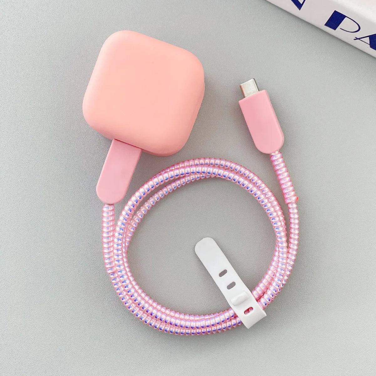 Frosted protective case for charger and cable.”